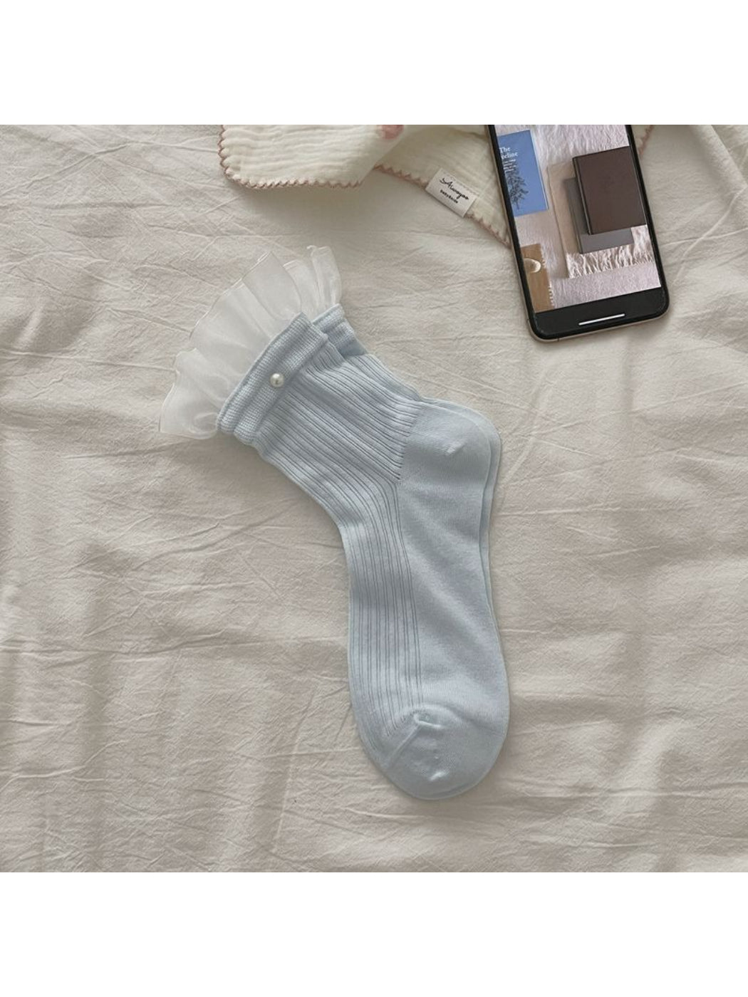 Rufia sheer ruffle trim crew socks in white folded neatly
