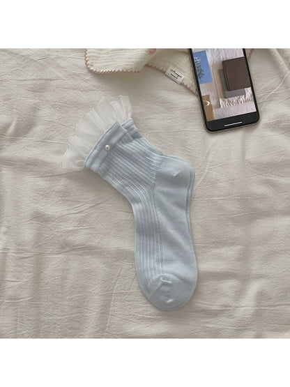 Rufia sheer ruffle trim crew socks in white folded neatly
