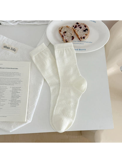 Rufia neutral textured crew socks worn on feet showing fit and length