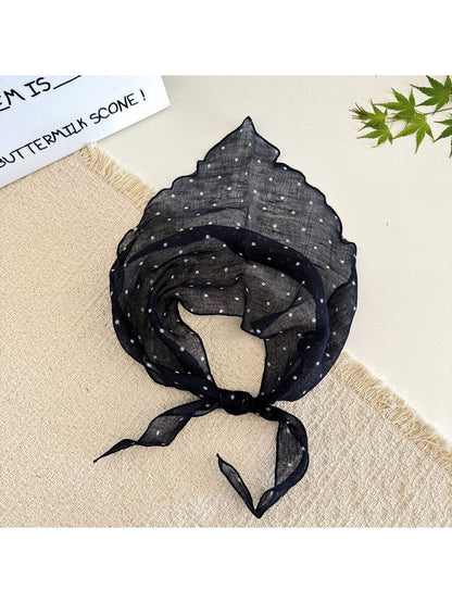 Flat lay of Scarvii soft textured polka dot head scarf showing fabric detail