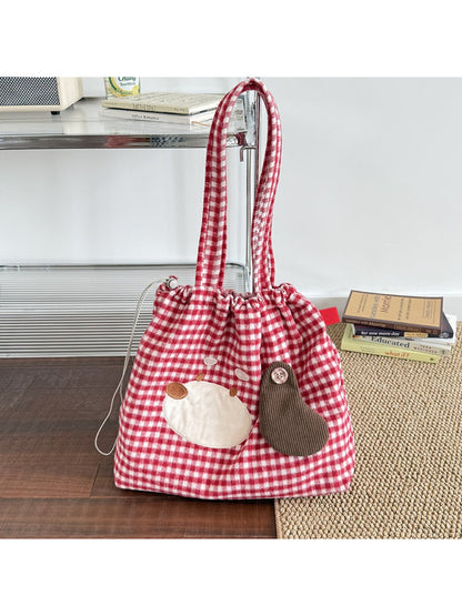 Cosbai Puppy Gingham Drawstring Tote held by hand showing size and shape