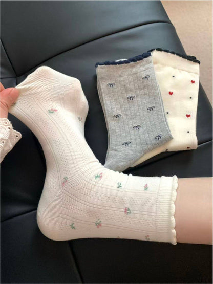 Rufia mixed motif lace trim crew socks folded, showing texture and design