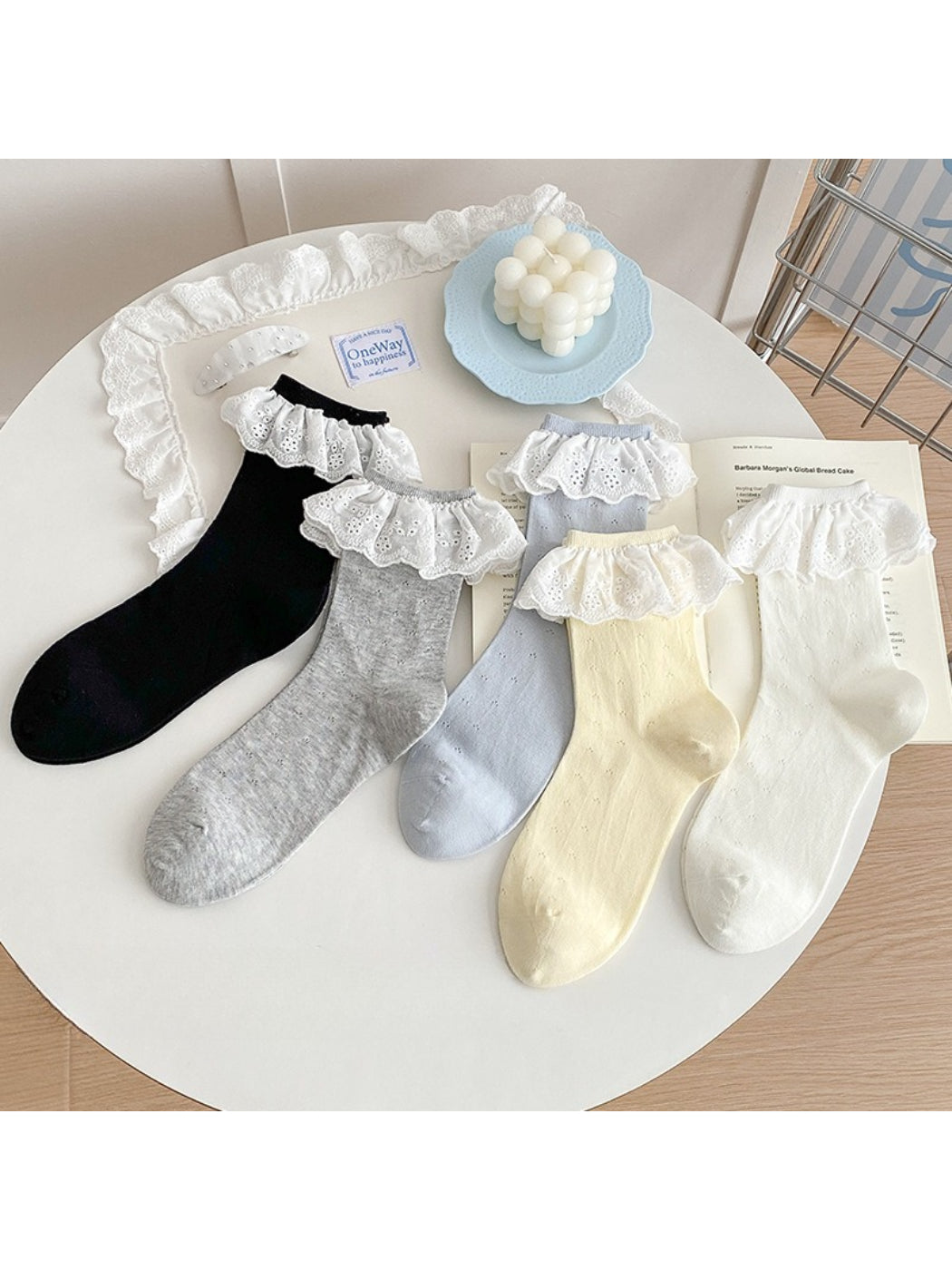 Close-up of Rufia lace ruffle trim crew sock in white on wooden surface