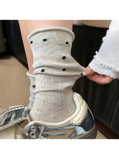 Rufia mid-calf socks with ruffle trim and mesh dot pattern shown from front angle