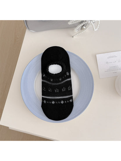 Rufia floral low cut socks folded neatly on a wooden surface
