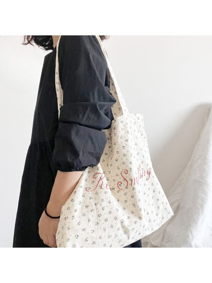 Close-up of floral design and lettering on Cosbai vintage tote bag showing detailed print