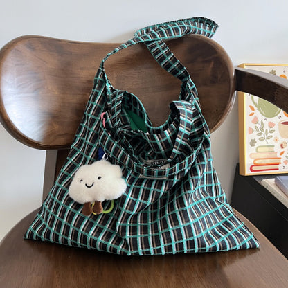 Model carrying Cosbai slouchy checked shoulder tote bag on shoulder