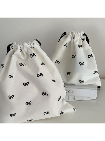 Cosbai bow pattern drawstring pouch shown partially open