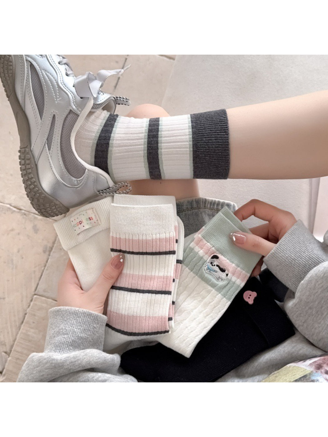 Pair of Rufia everyday crew socks with colorful playful stripe pattern on white background