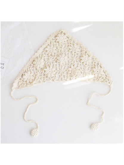 Close-up of cream crochet headband showing detailed floral pattern