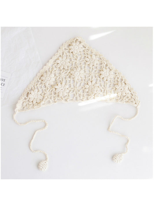 Close-up of cream crochet headband showing detailed floral pattern