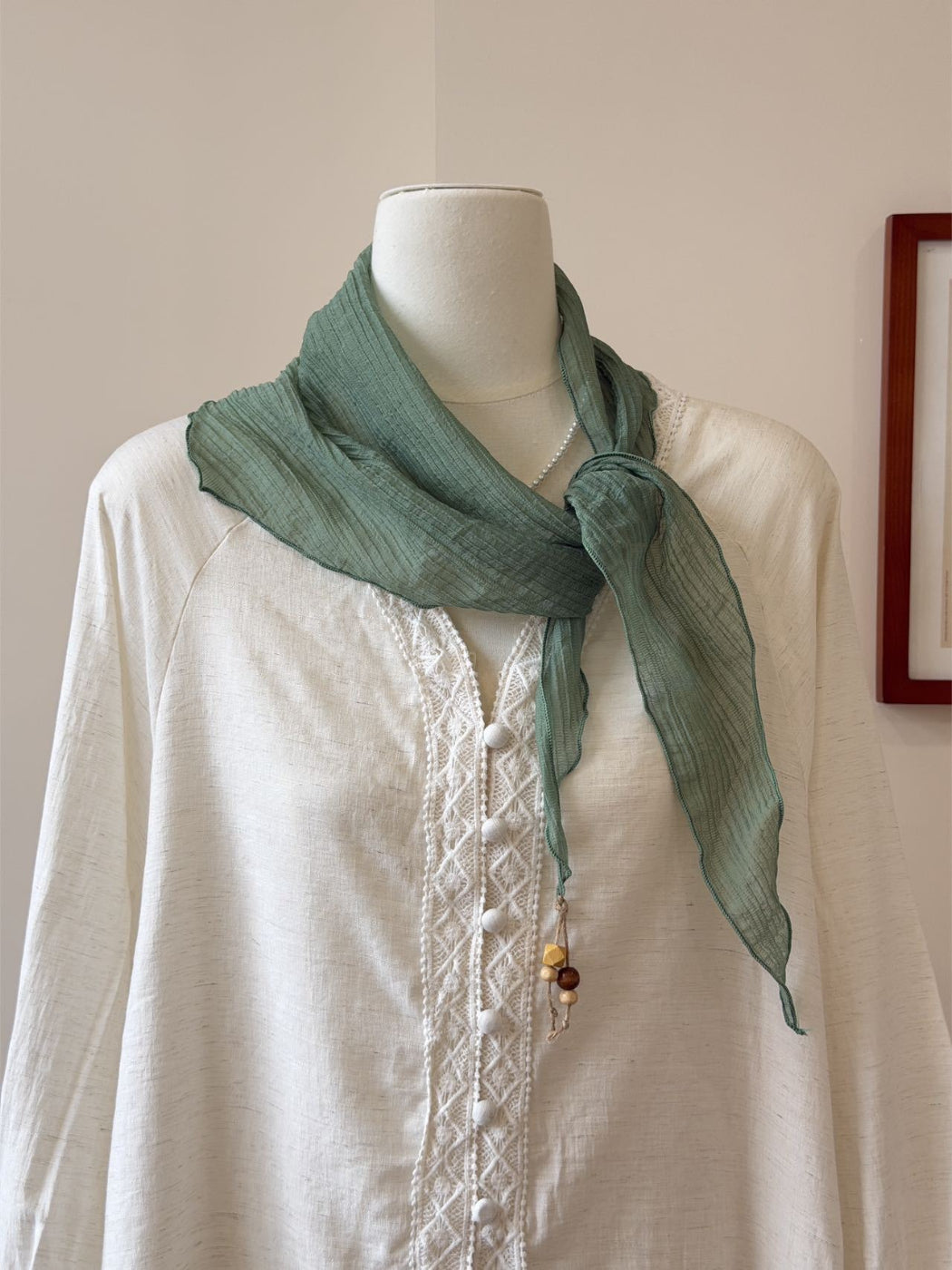 Close-up of scarf fabric texture showing soft, lightweight material