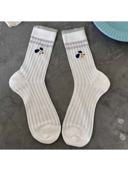 Pair of Rufia Playful Pup socks laid flat displaying full dog pattern design