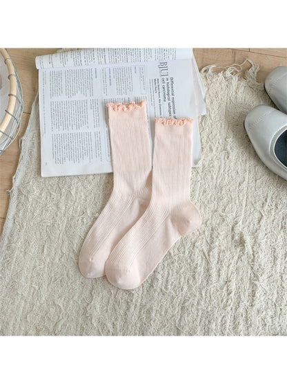 Rufia socks folded neatly to showcase frill trim and soft knit material
