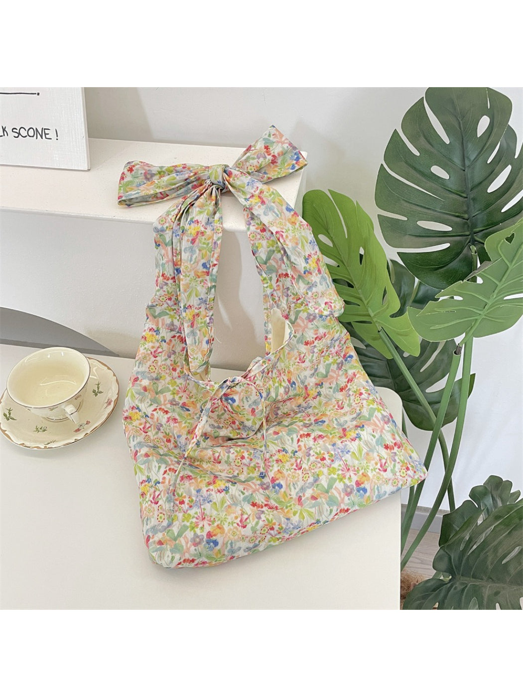 Side view of Cosbai Ditsy Floral Bow Strap Tote Bag showing strap and floral design