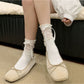 Pair of Rufia Ribbon Ruffle Crew Socks laid flat highlighting ruffle design
