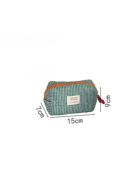 Cosbai quilted cosmetic pouch displayed on a vanity with makeup items
