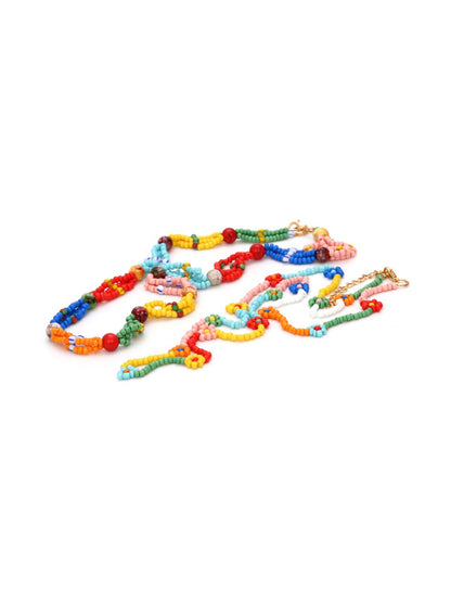 Neckit multi strand beaded necklace with floral detail arranged flat for display