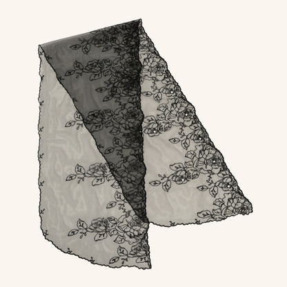 Close-up of Scarvii sheer wrap fabric highlighting delicate floral design and texture