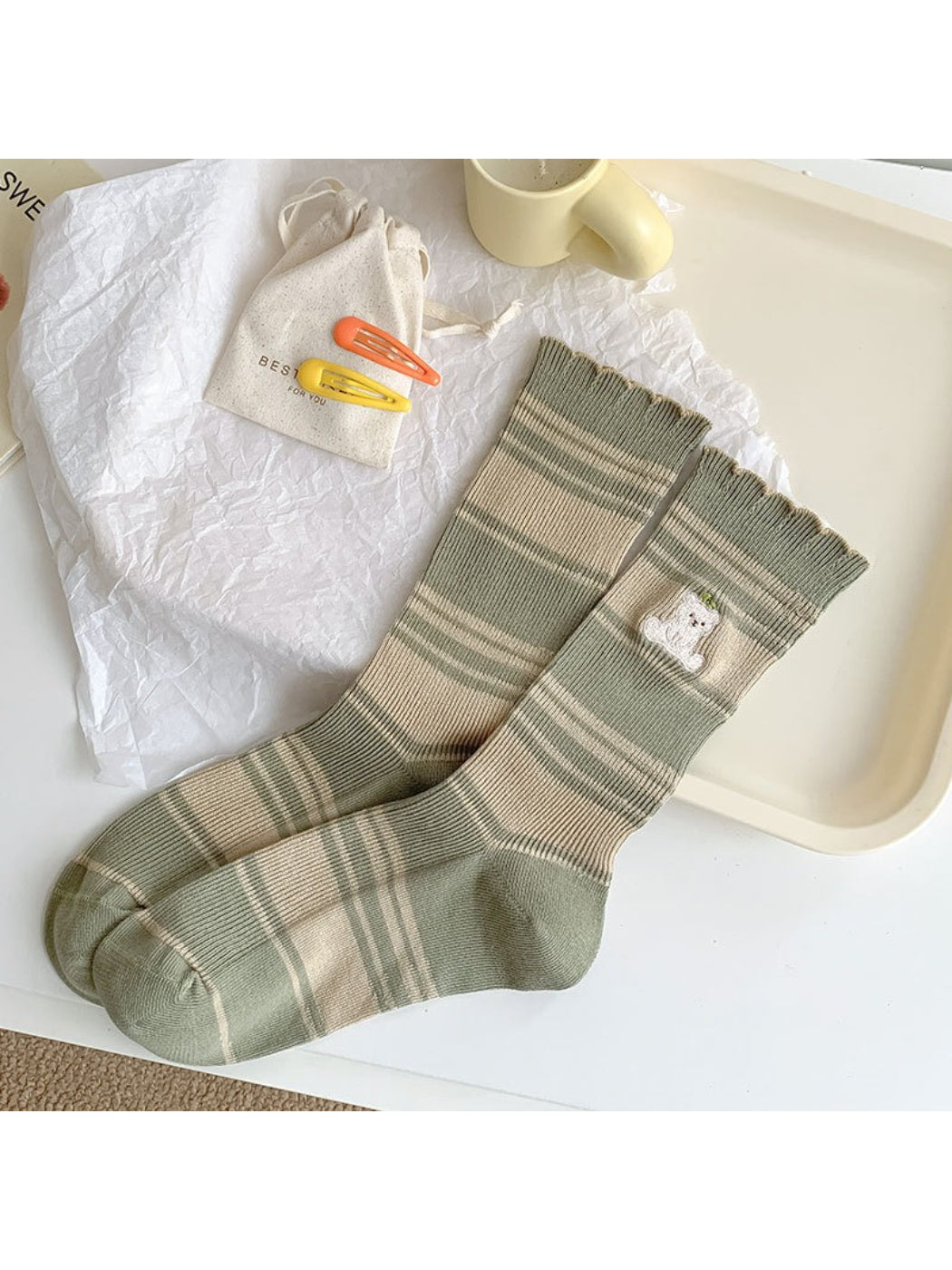 Pair of Rufia Soft Stripe Bear Crew Socks styled with casual footwear