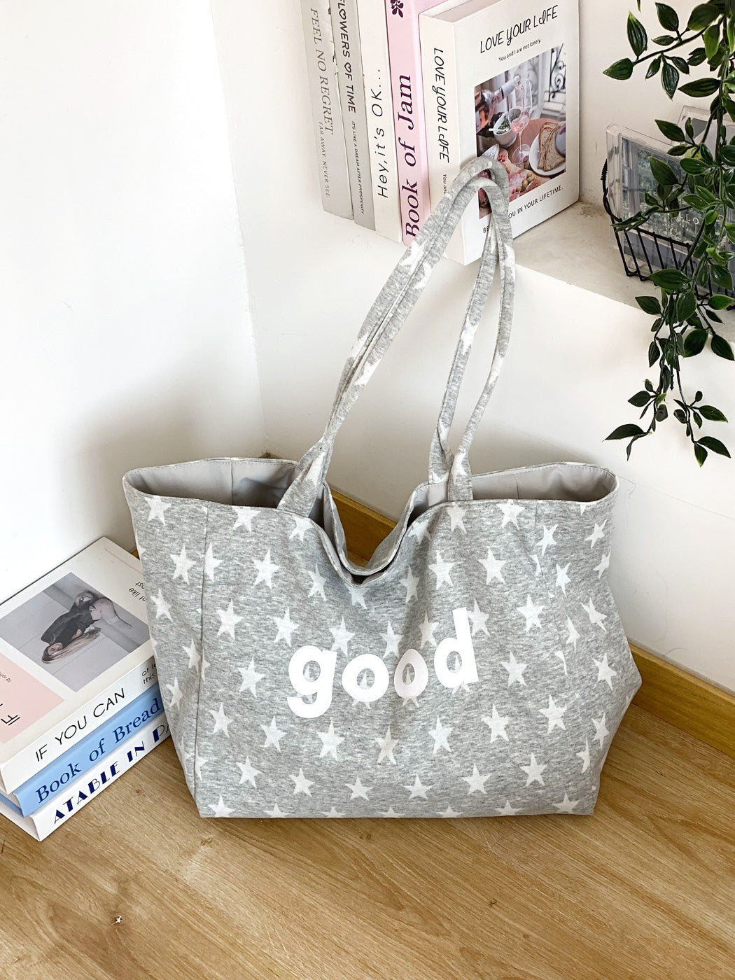 Side view of Cosbai star print tote bag showing handles and stitching