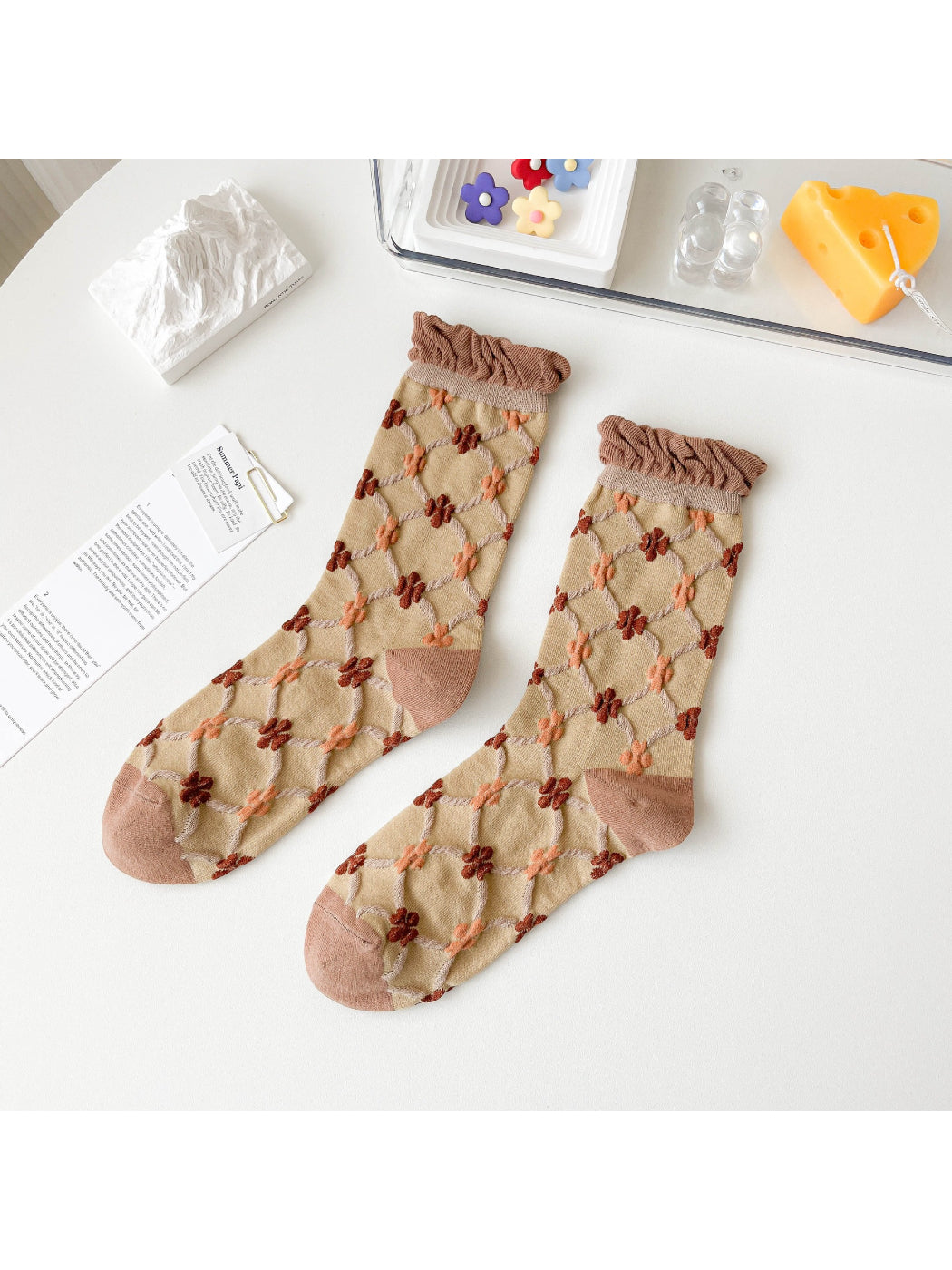 Rufia Woodland Bloom socks styled with casual outfit on a wooden floor background