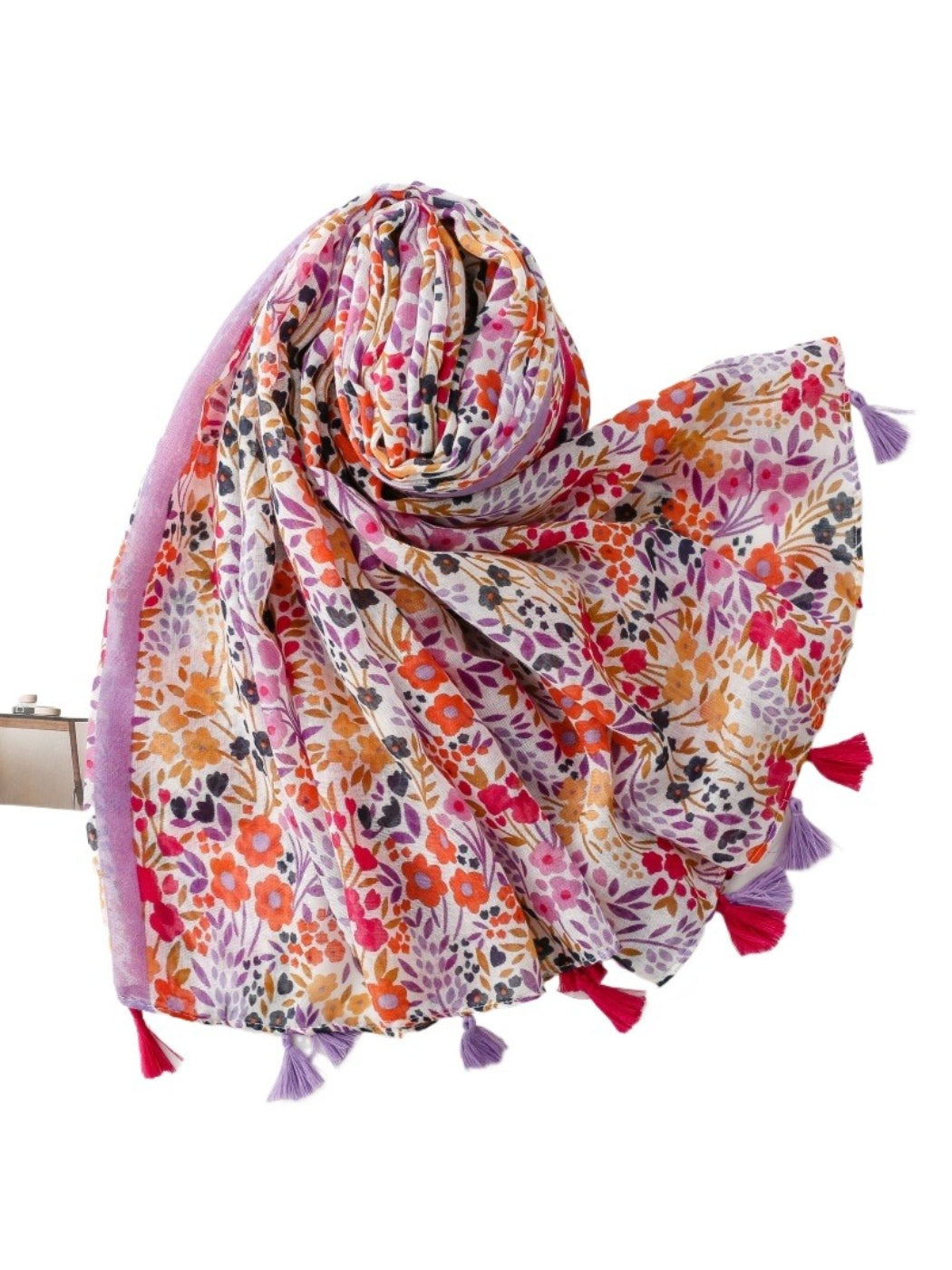 Close-up of vibrant floral pattern and tassel details on scarf fabric