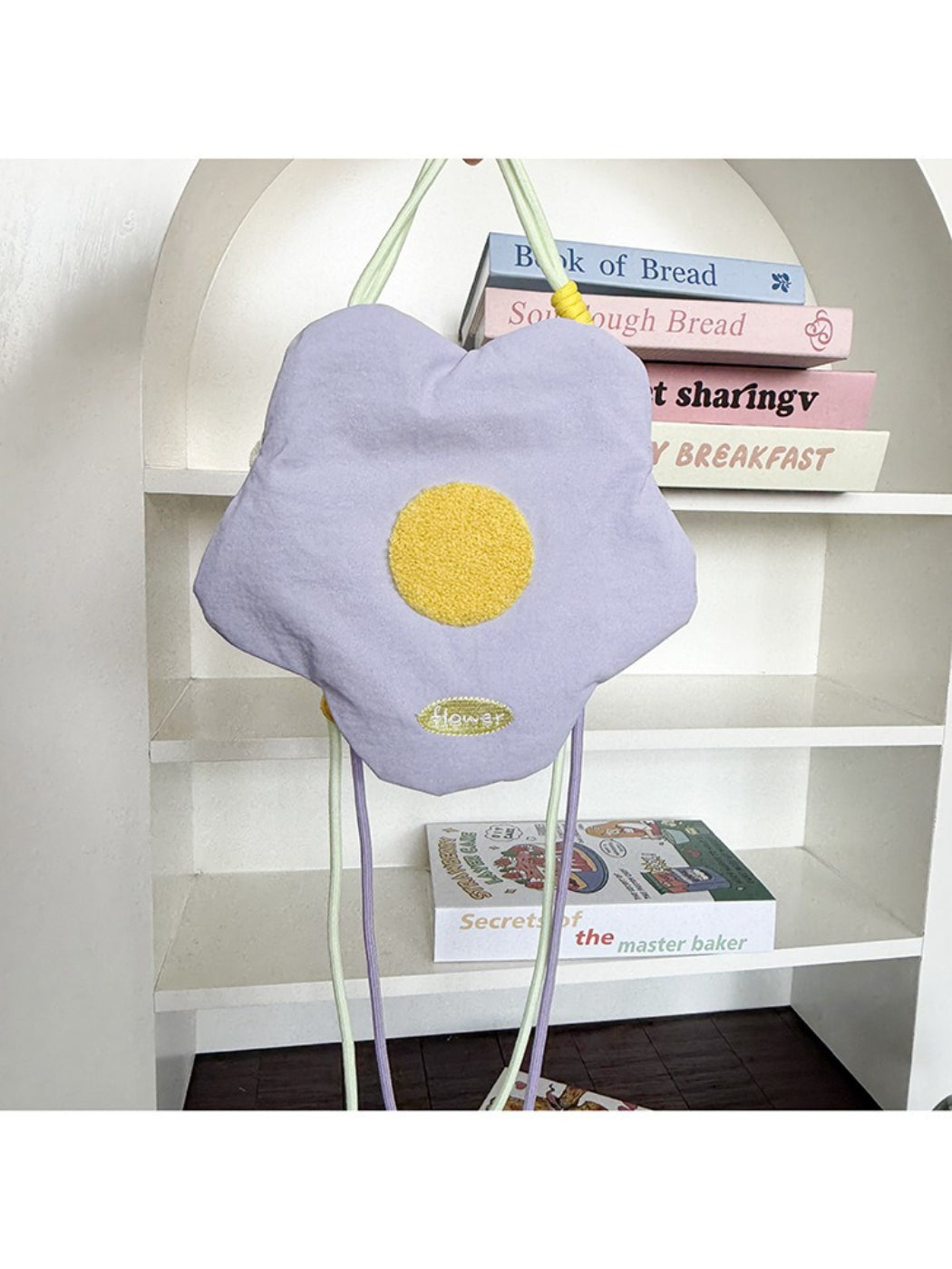 Cosbai floral mini crossbody coin pouch with strap coiled beside it on white background