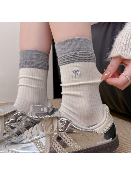 Close-up of Rufia embroidered ribbon ribbed slouch socks showing detailed embroidery on ribbed fabric