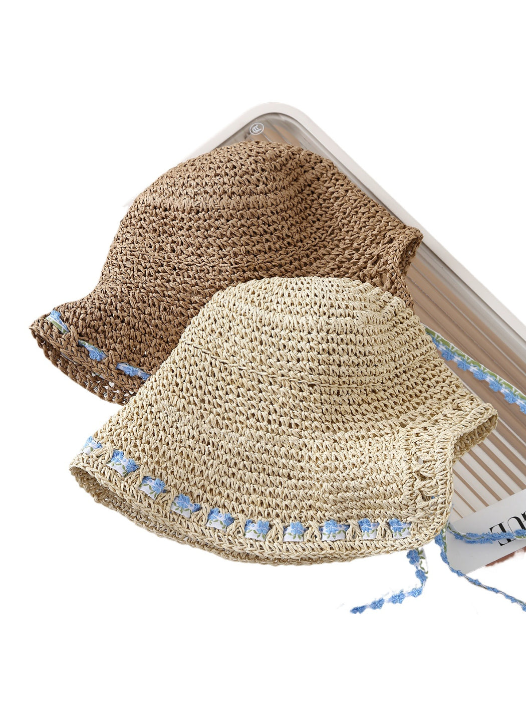 Side view of Haila floral trim straw bucket hat showing detailed floral trim