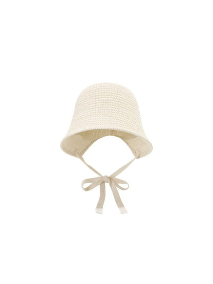 Close-up of Haila woven straw bucket hat showing detailed straw texture and ribbon tie