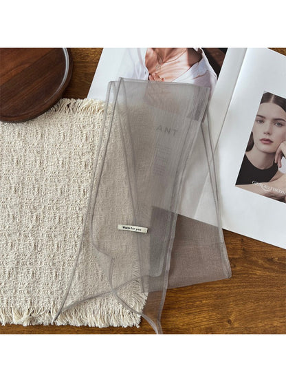 Scarf wrapped multiple times around wrist as a stylish accessory