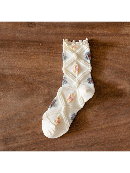 Rufia crew socks folded to highlight mesh floral design and soft texture