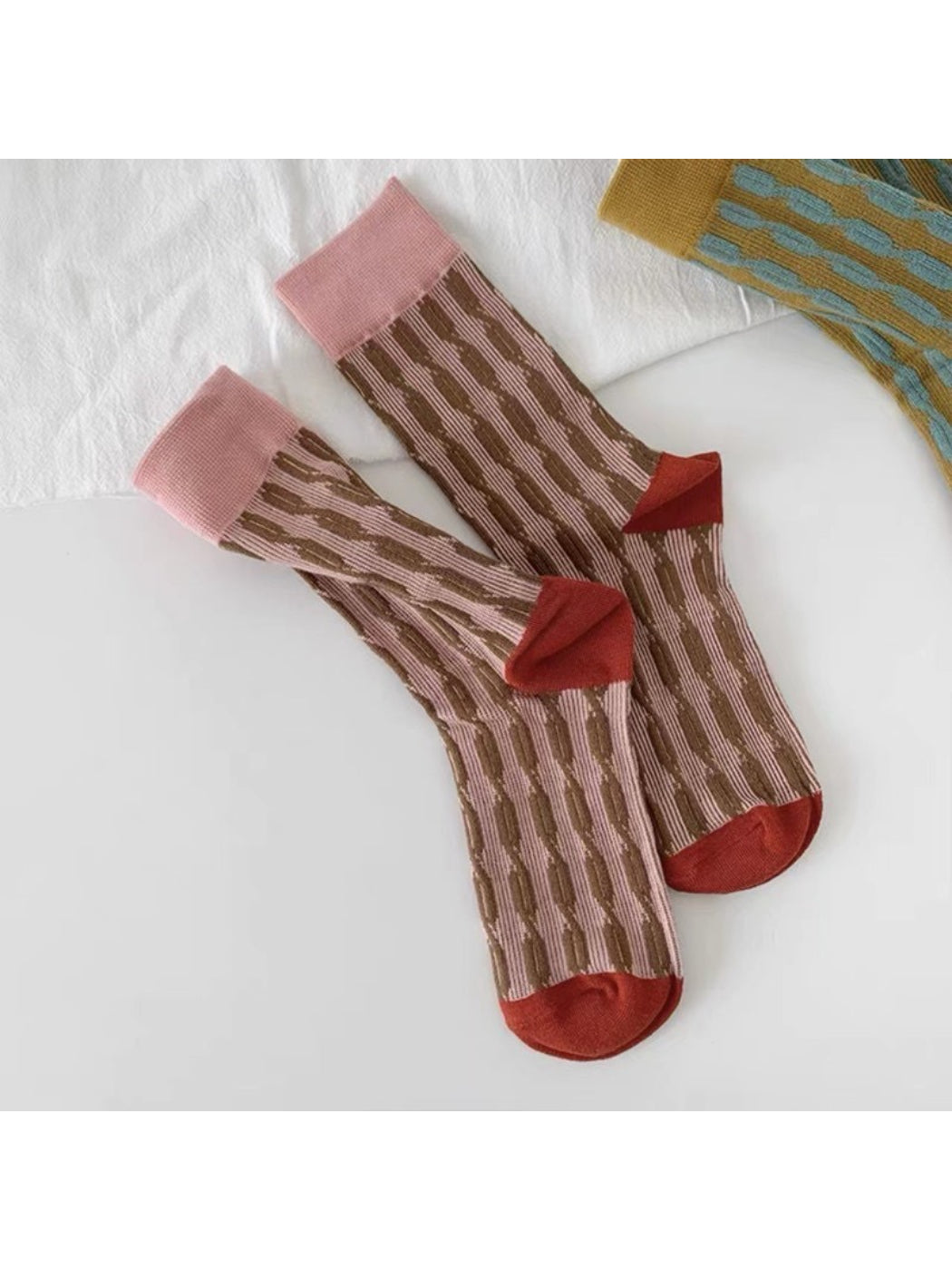 Rufia crew socks worn with casual shoes, highlighting bold knit pattern