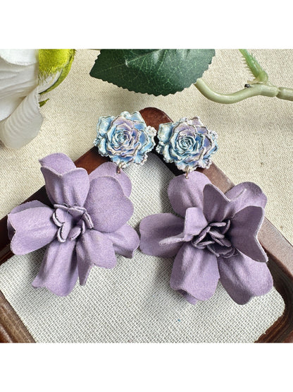 Model wearing Earwish purple floral drop earrings showcasing length and style