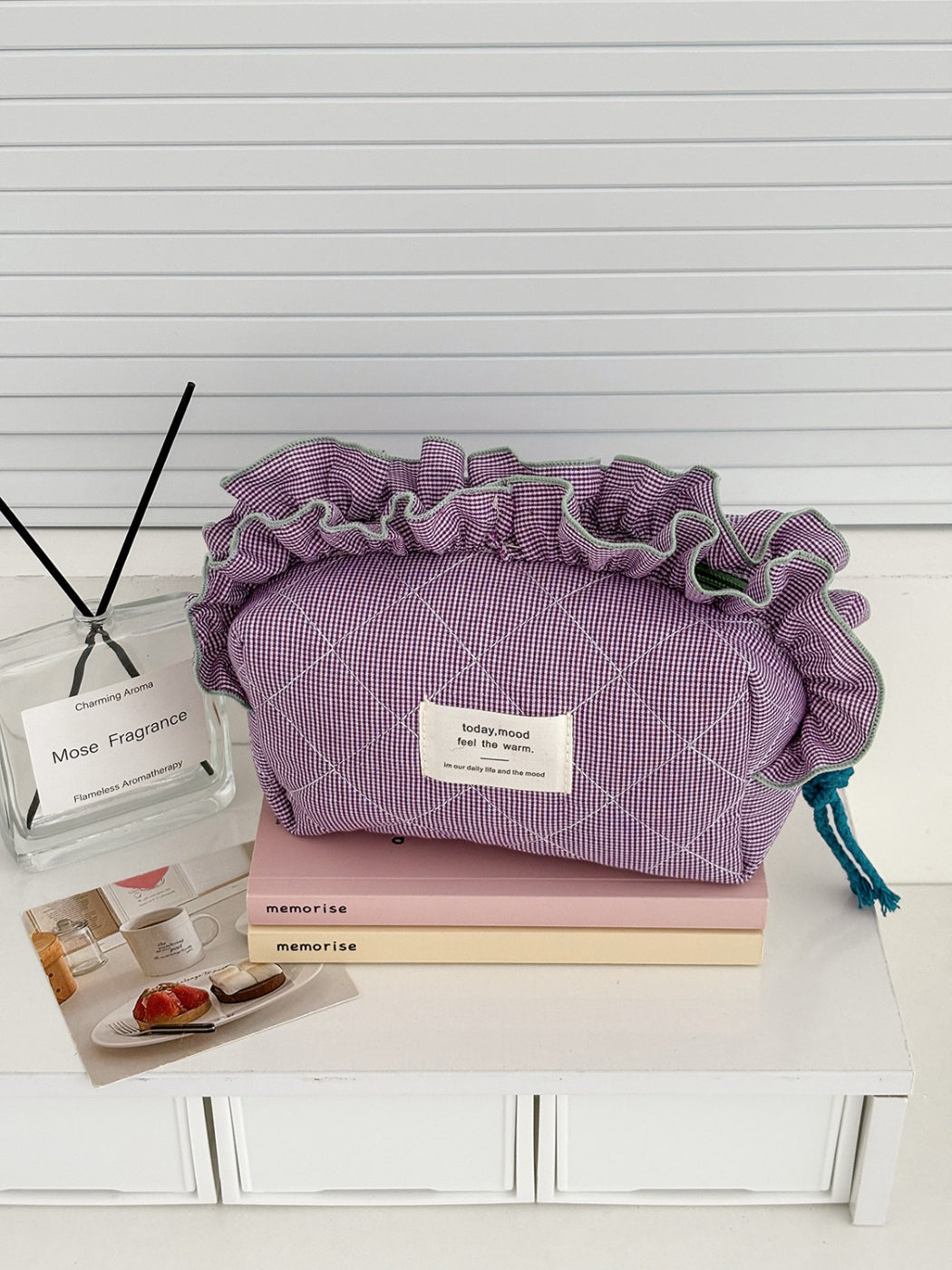Side view of Cosbai ruffle trim gingham makeup bag with black and white checks