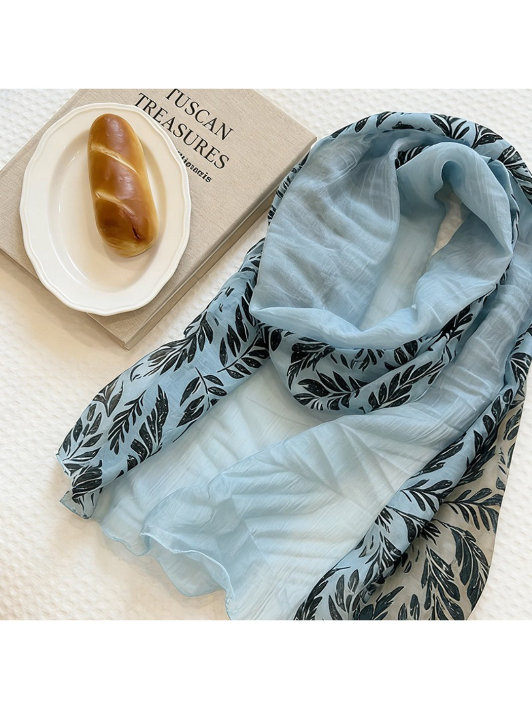 Scarvii neck scarf displayed with complementary accessories on table