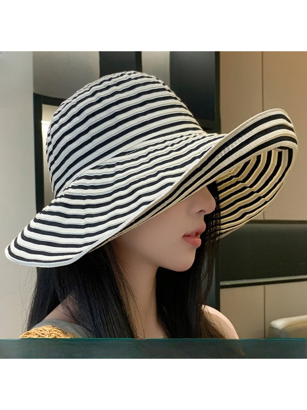 Back view of Haila striped wide brim sun hat on model highlighting the hat shape