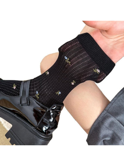 Side view of Rufia crew socks highlighting soft blossom pattern and ribbed cuff