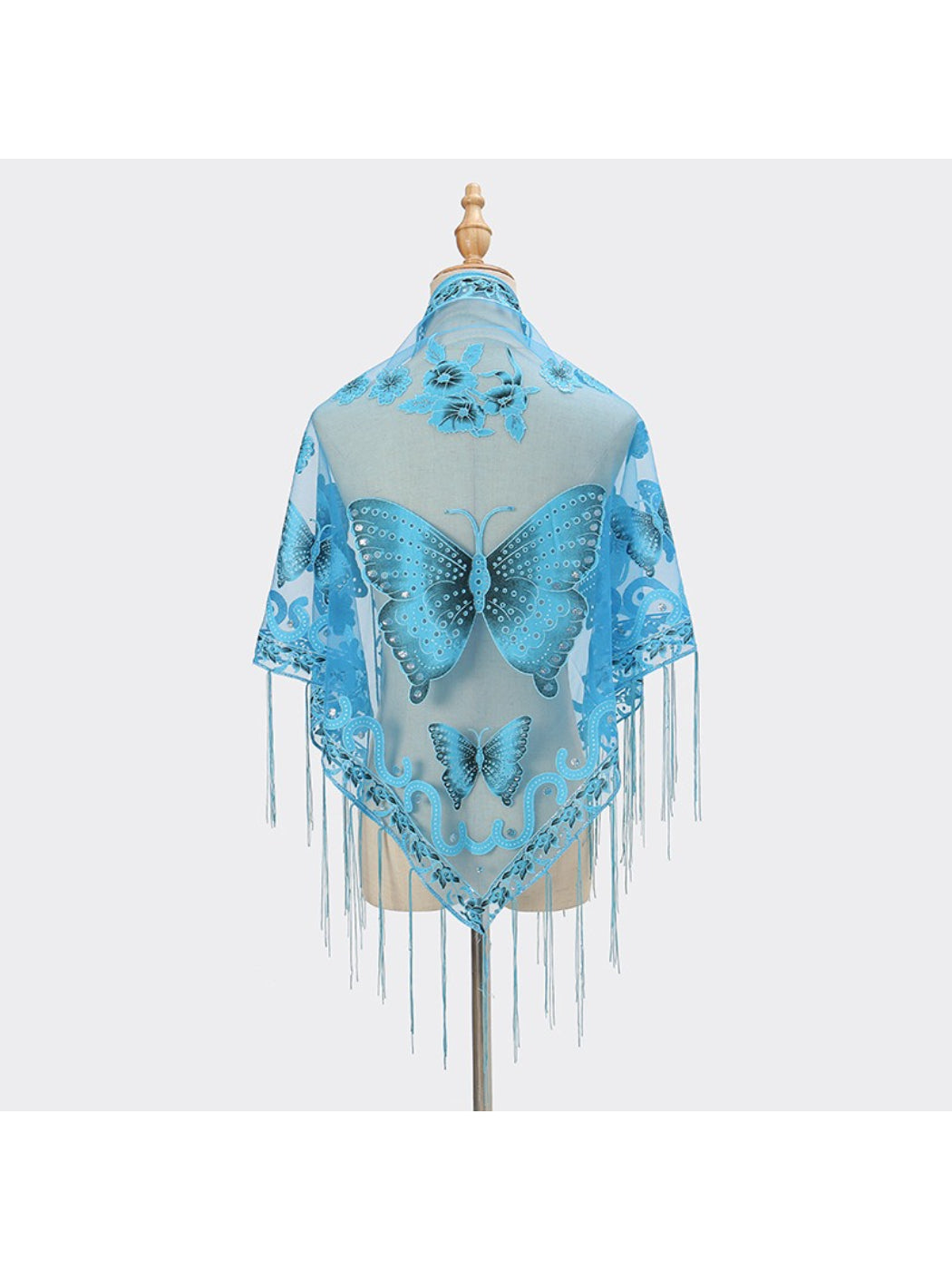 Model wearing Scarvii Butterfly Fringe Triangle Scarf styled as a shawl with fringed edges