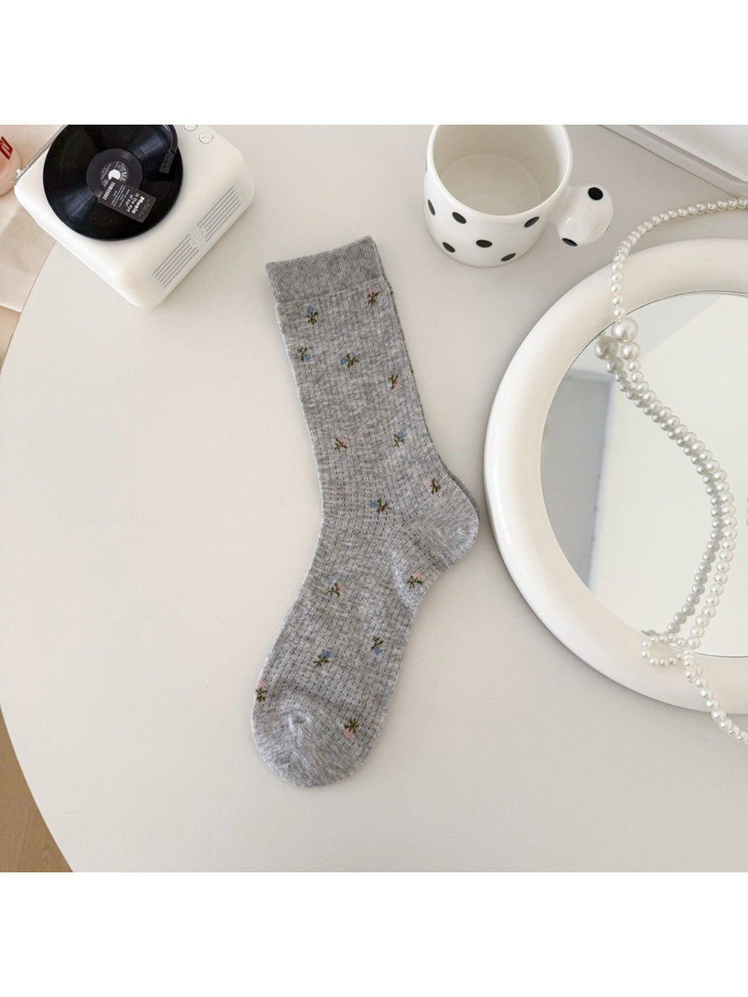 Rufia socks folded to show soft blossom pattern and fabric texture