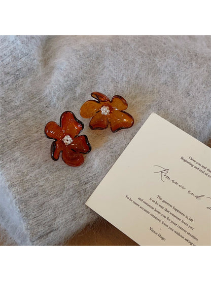 Earwish Rounded Petal Bloom Earrings in gold displayed alongside matching jewelry pieces