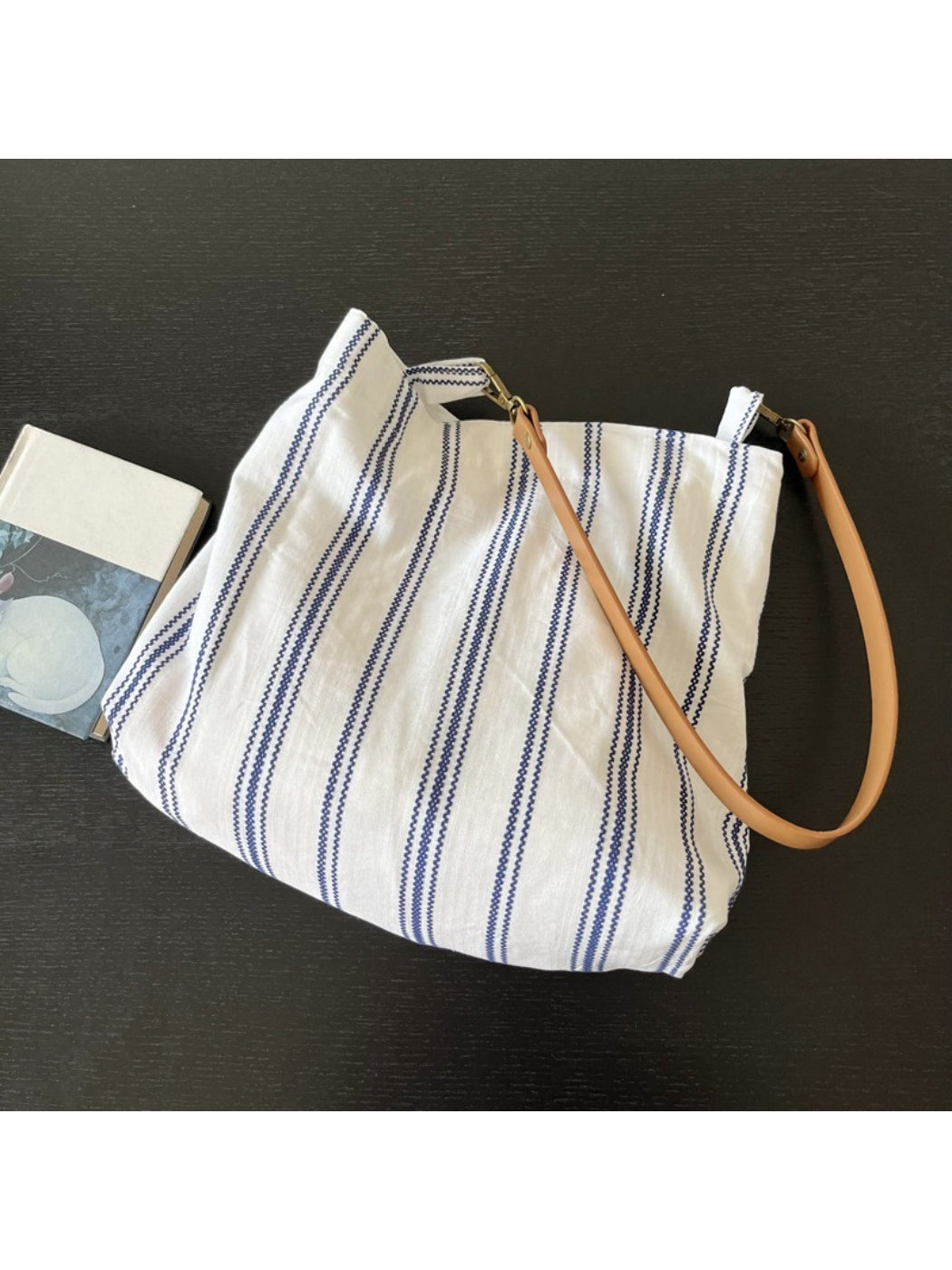 Close-up of Cosbai blue stripe slouch shoulder bag showing fabric texture and strap detail