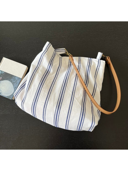 Close-up of Cosbai blue stripe slouch shoulder bag showing fabric texture and strap detail