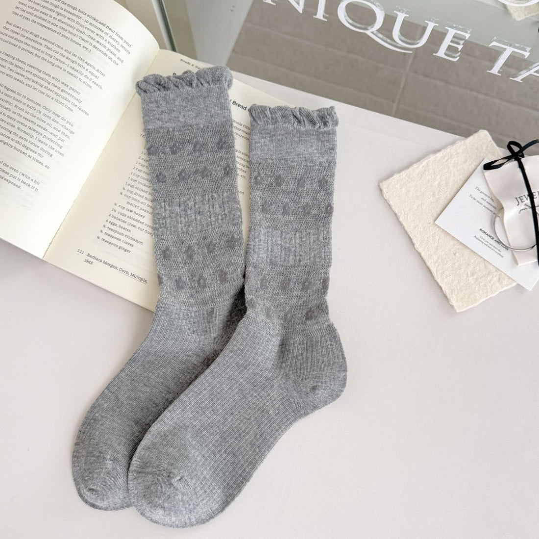 Top view of Rufia floral trim ribbed crew socks showing scalloped floral trim and ribbed pattern
