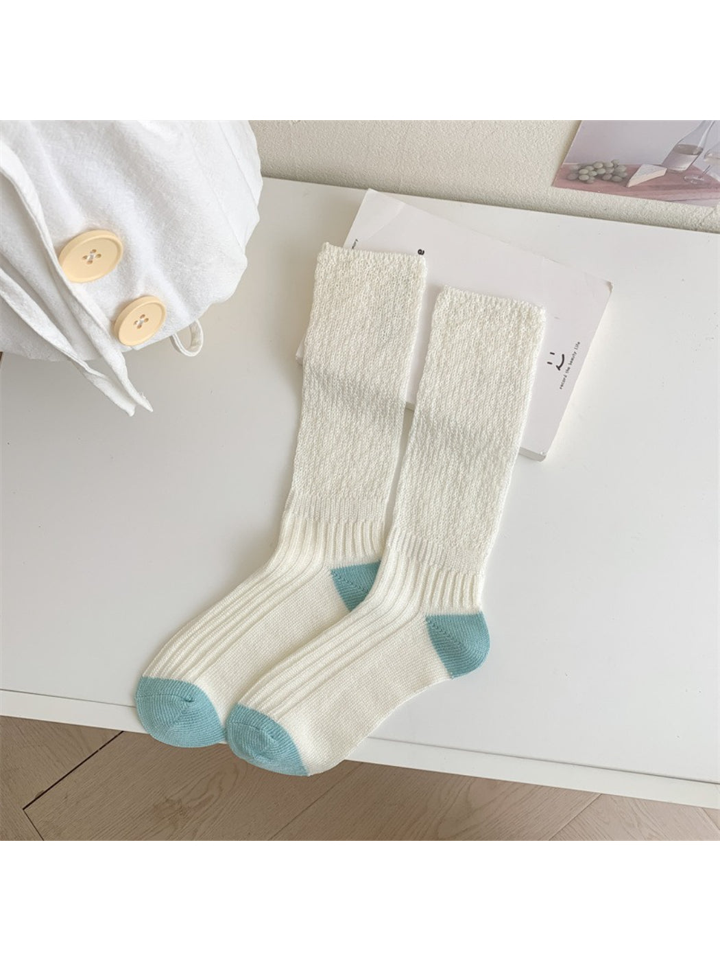 Rufia socks laid flat showing full length and contrasting toe color