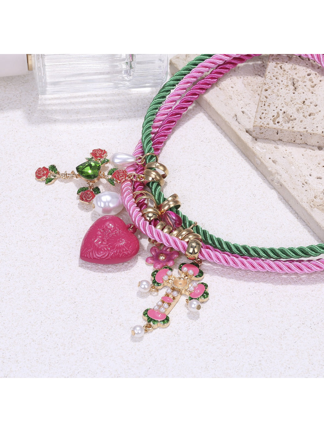 Close-up of Neckit color rope charm necklace showing heart detail on rope chain