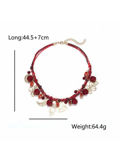 Neckit necklace with beads and floral charms shown against a soft white backdrop