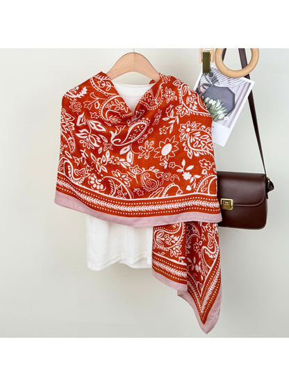 Model wearing Scarvii Western Paisley Wrap Scarf draped over shoulders with fringe detail