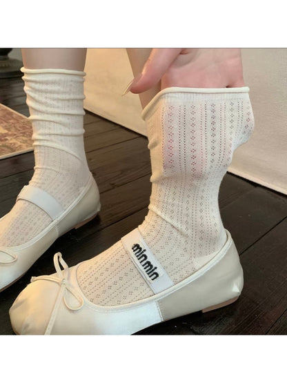 Model wearing Rufia ribbed mid-calf socks in light beige